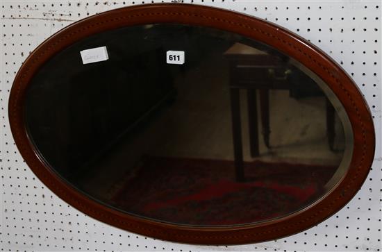 Oval wall mirror in inlaid frame